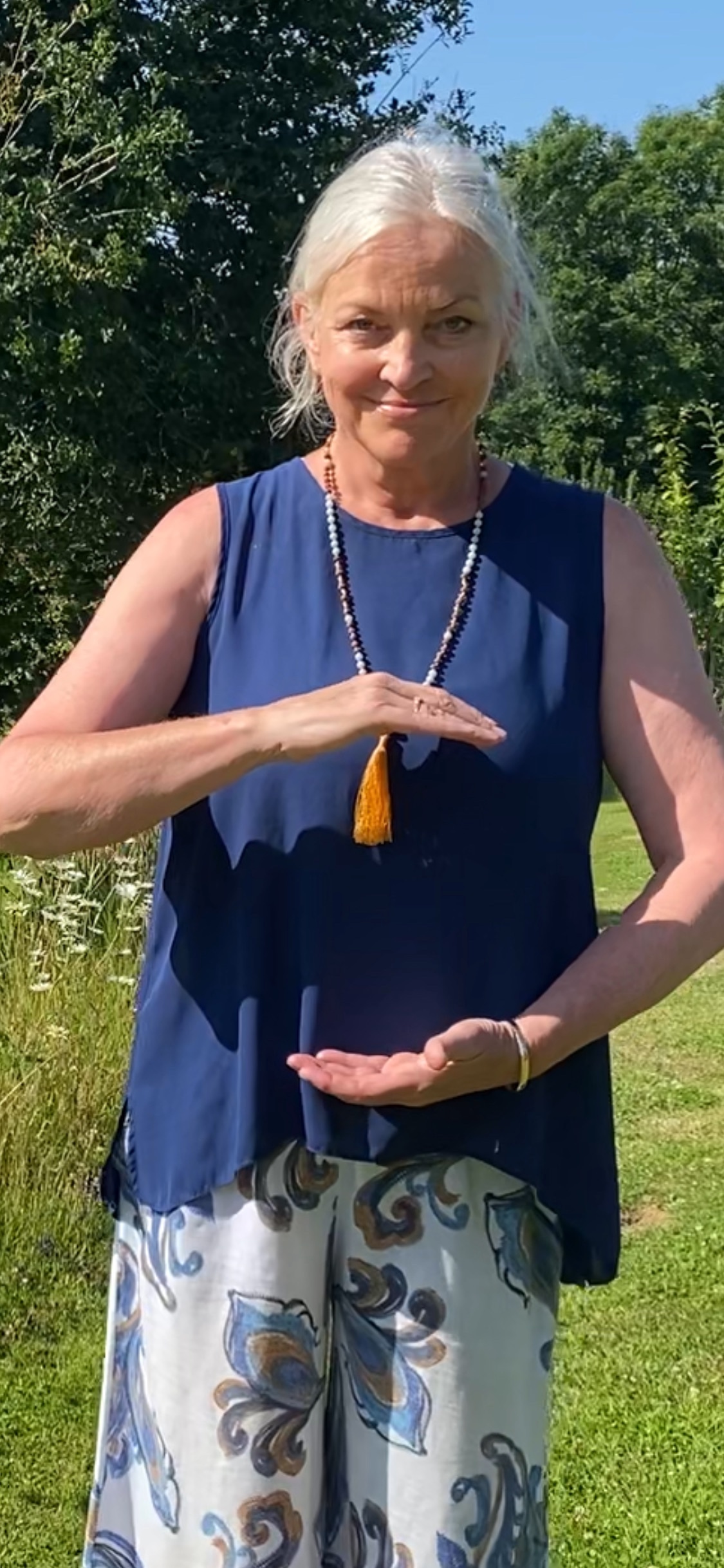 Qigong practitioner with hands in front of the body as if holding an 'energy ball'