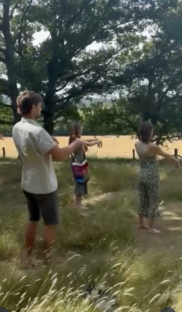 People practicing Qigong in the woods at the Harry Edwards Healing centre in Shere, Surrey